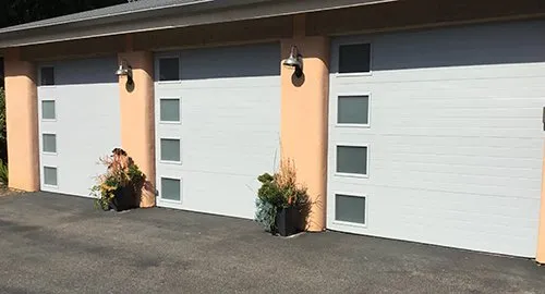 Gray grooved garage door installed by Bedford Overhead Doors