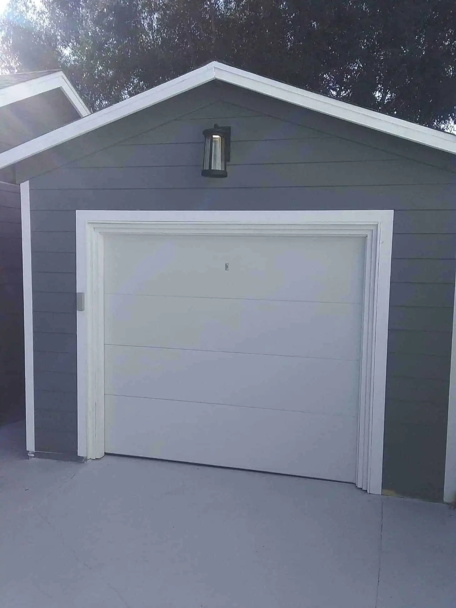 White flat-panel garage door installed by Bedford Overhead Doors